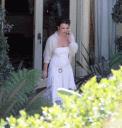 Britney Spears in white dress on phone in back yard